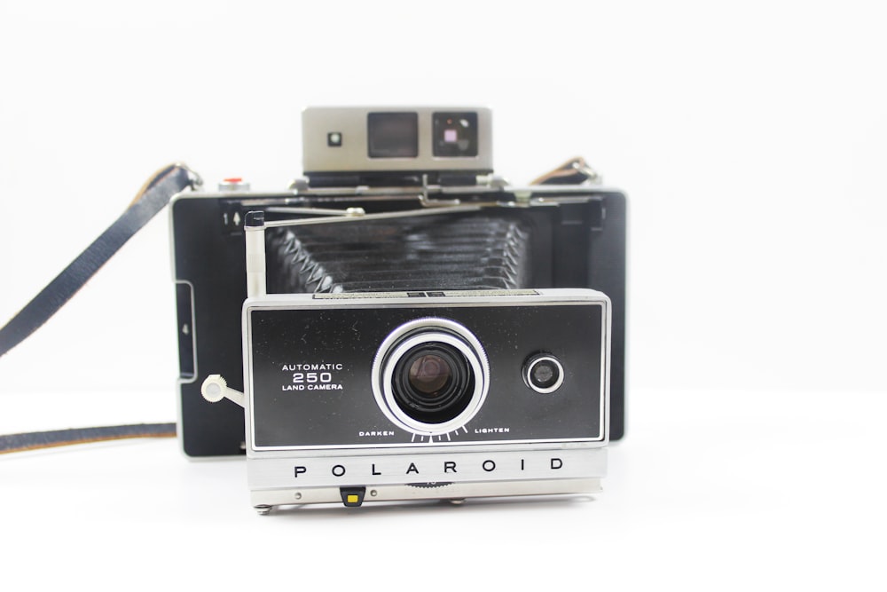 black and silver Polaroid folding camera