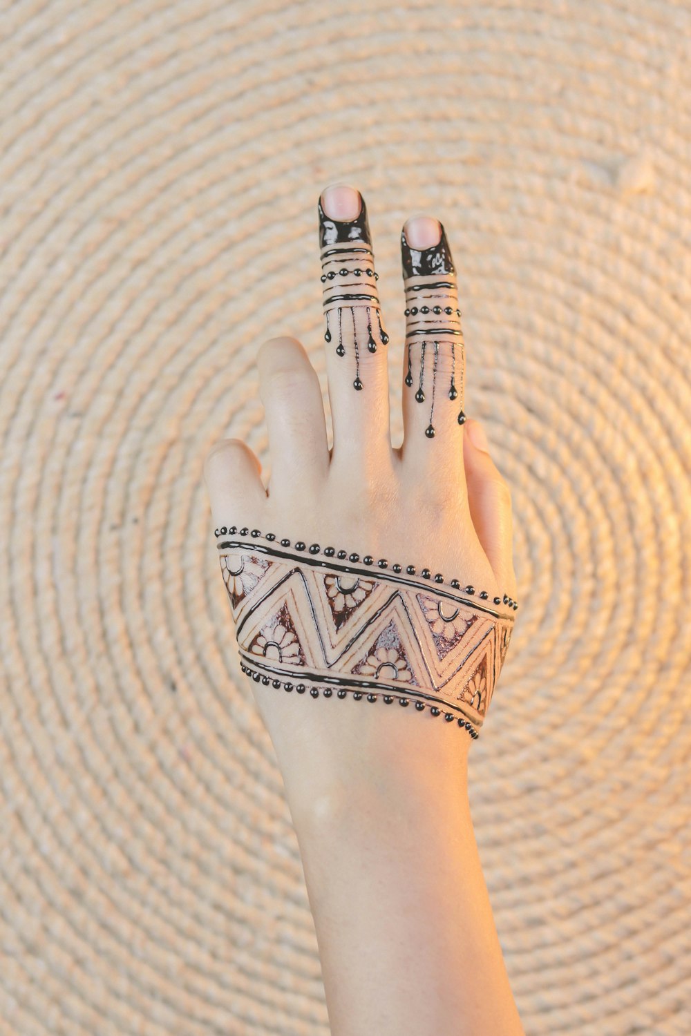 black henna covered left hand
