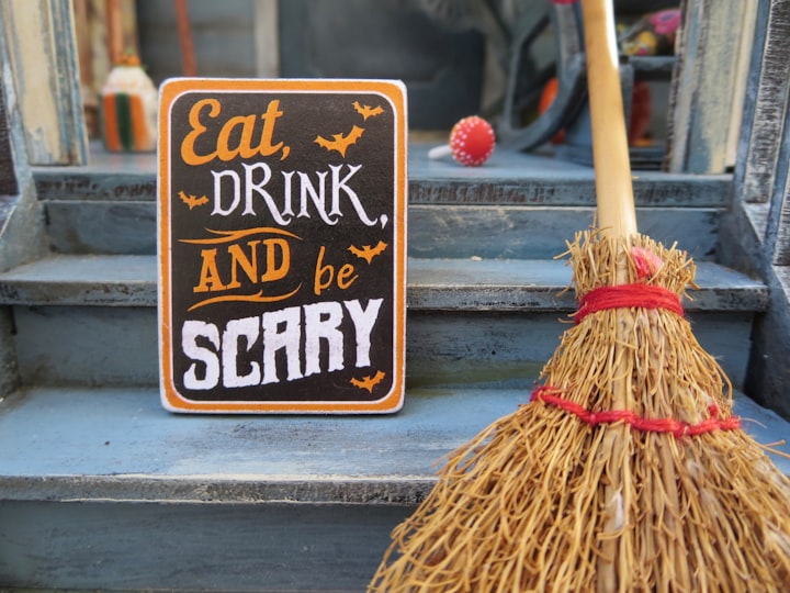 Eat, drink and be scary sign on doorstep for Halloween party.