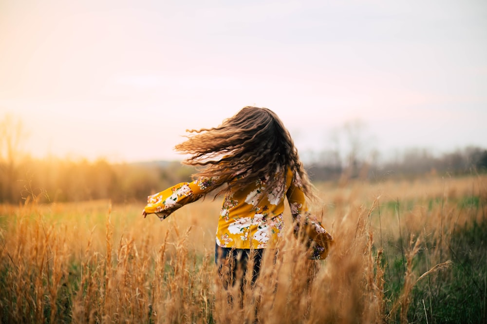 woman walking on field at daytime