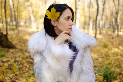 woman wearing white faux fur coat fur teams background