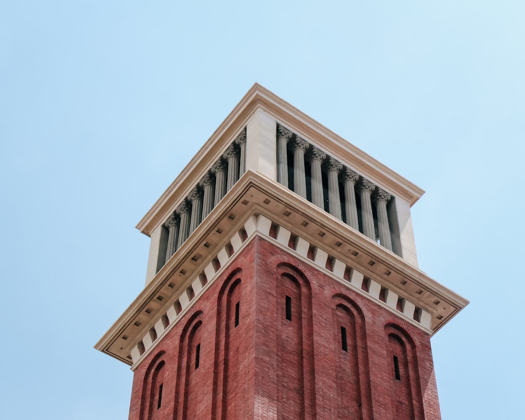 red and brown concrete building, The upper part of an Egyptian style tower in front of the National Museum of Art of Cat