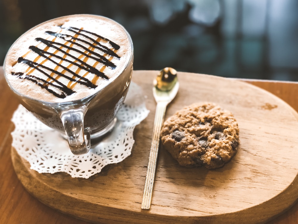 clear glass coffee cup beside spoon