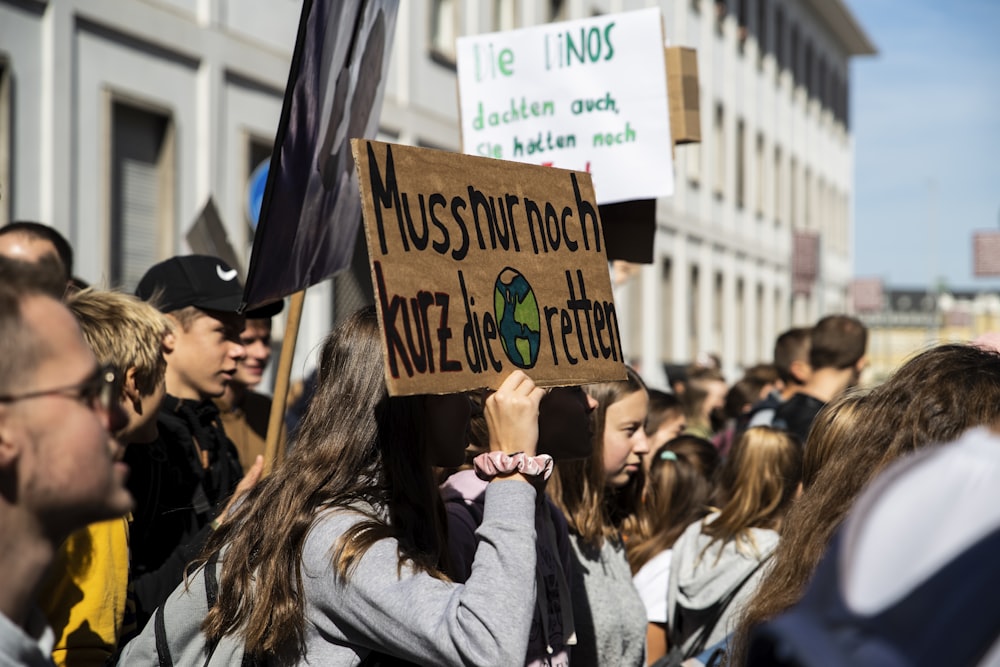 people outside building holding assorted placards