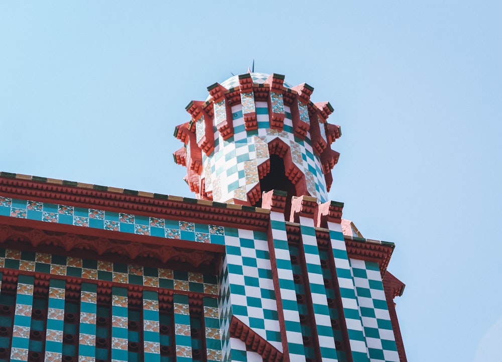 a clock on top of a building with a sky background