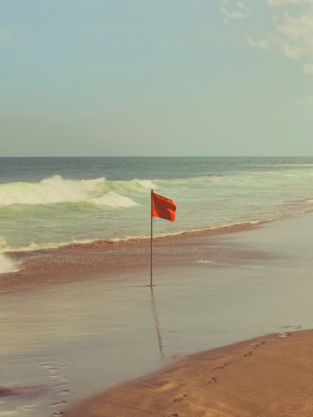 해변에 장대가 있는 붉은 깃발