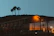 A modern builder floor exterior in Emerald Hills glowing under the evening sky.