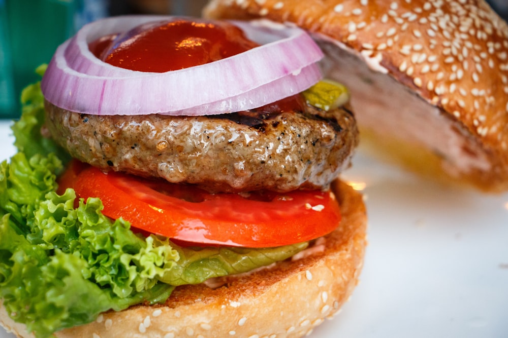 tasty burger with sliced onion and sesdame