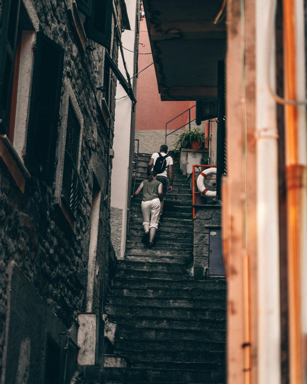 man and woman walking on stairs