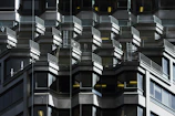 an abstract shadow play highlighting structural precision on a modern building exterior