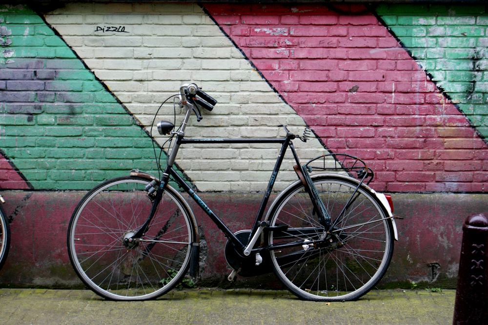 black bike leaning on wall