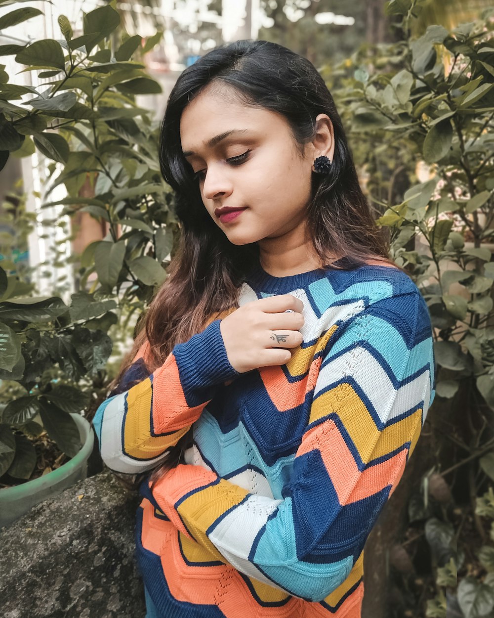 woman wears multicolored chevron sweater