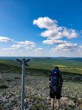 A traveler standing on a scenic overlook with a custom itinerary map from Nesso Travels.