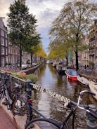 two blue bicycles parked on bridge in Amsterdam