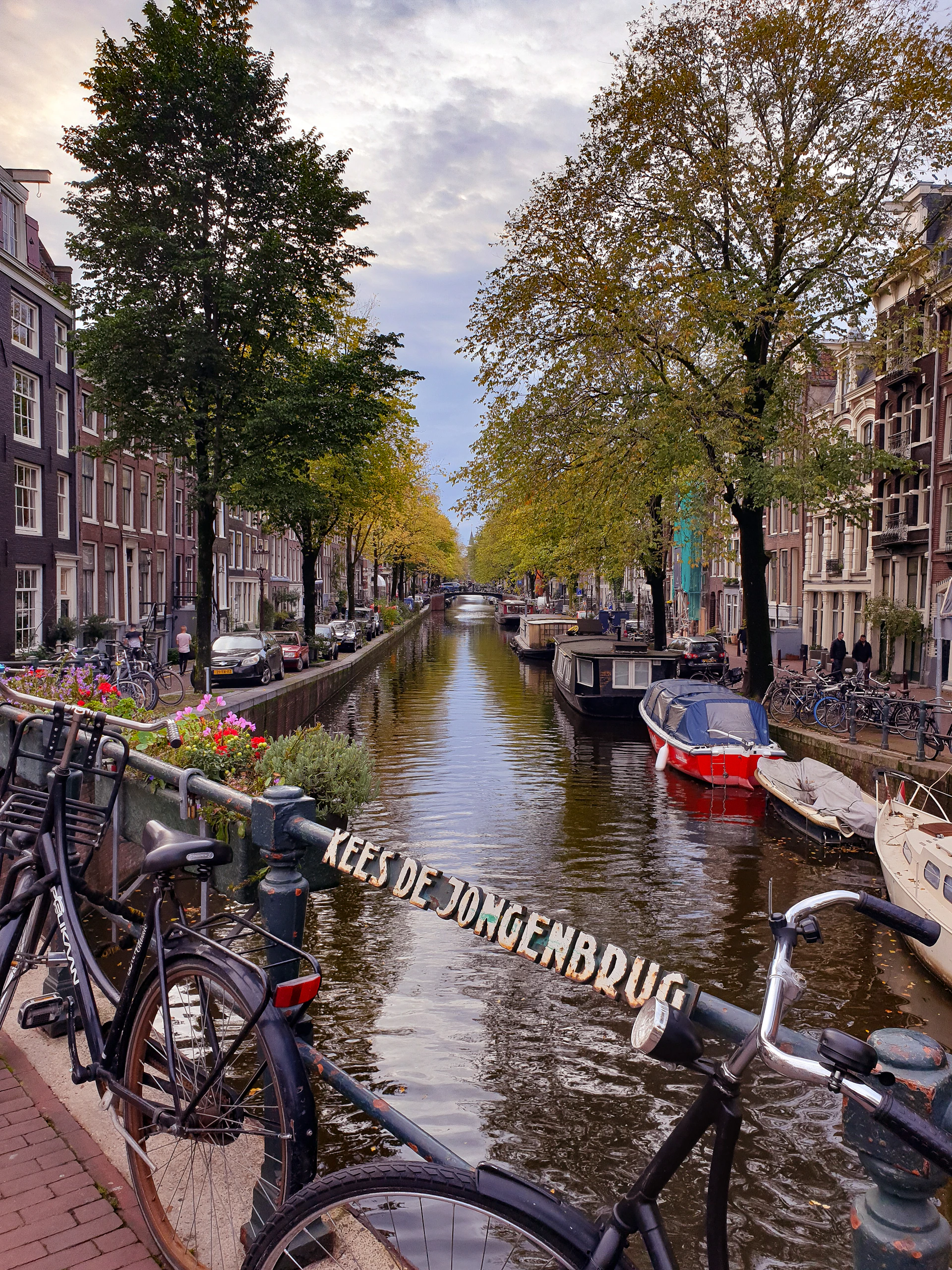 two blue bicycles parked on bridge in Amsterdam