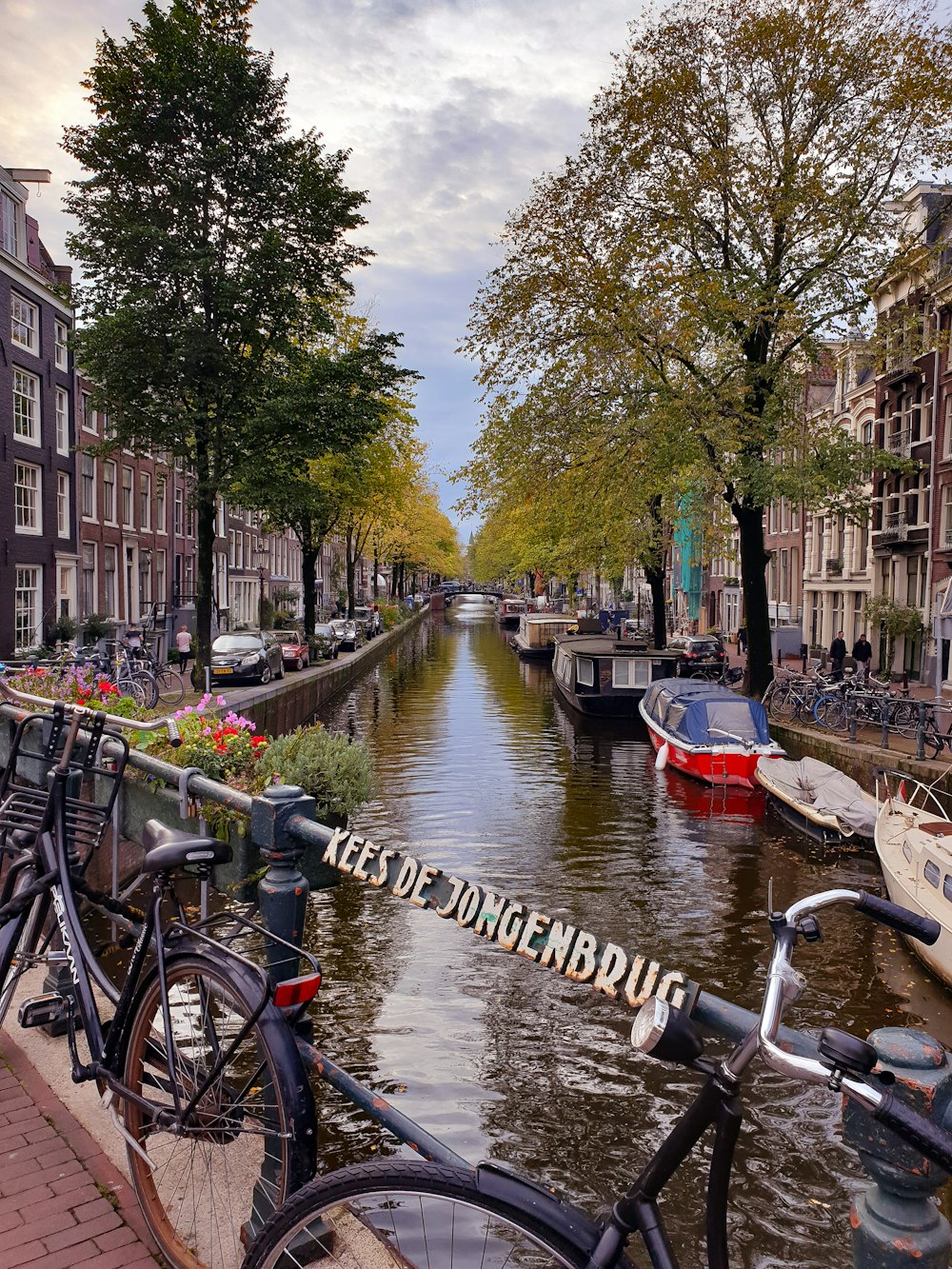 two blue bicycles parked on bridge in Amsterdam