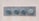 Four large metal bolts are embedded in a rectangular metal plate on a concrete wall. Each bolt has a round, flat head with a hexagonal base, showing signs of wear and tarnish.