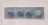 Four large metal bolts are embedded in a rectangular metal plate on a concrete wall. Each bolt has a round, flat head with a hexagonal base, showing signs of wear and tarnish.