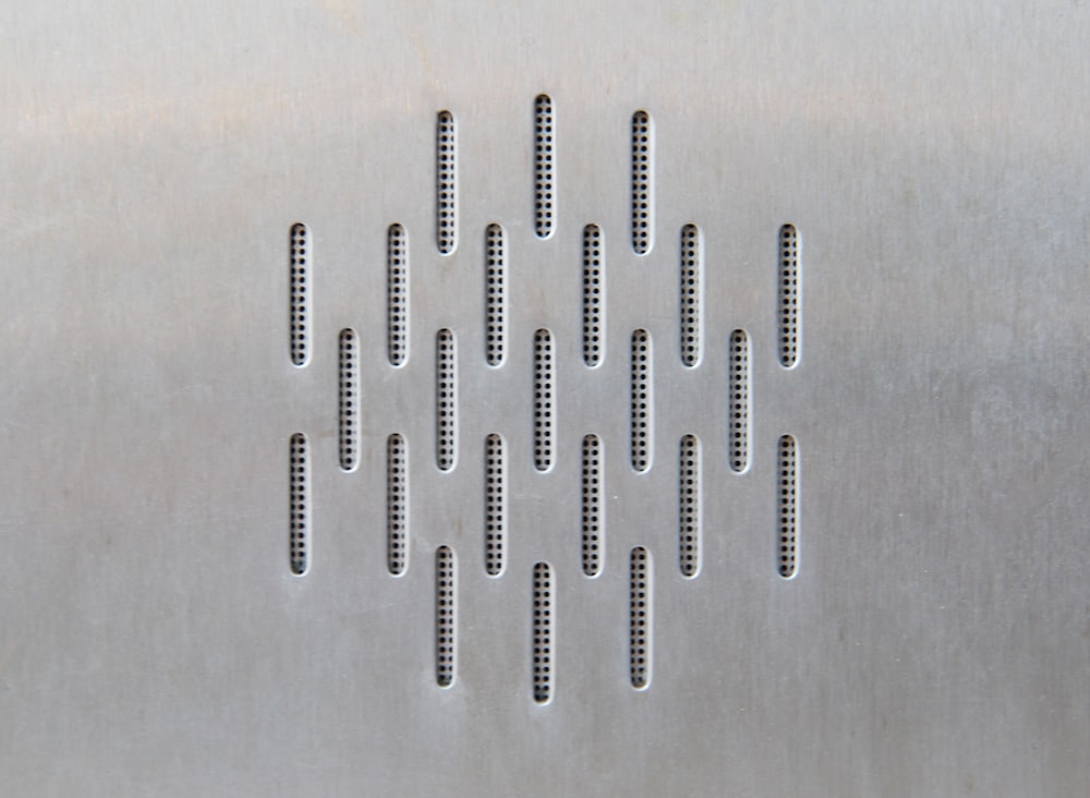 a close up of a metal object with holes in it