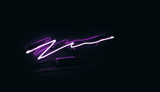 A glowing molecular structure illuminated with neon purple and blue lights against a dark gradient background.