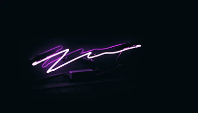 Close-up of a glowing neon menu interface on a tech-inspired web page with dark purple background.