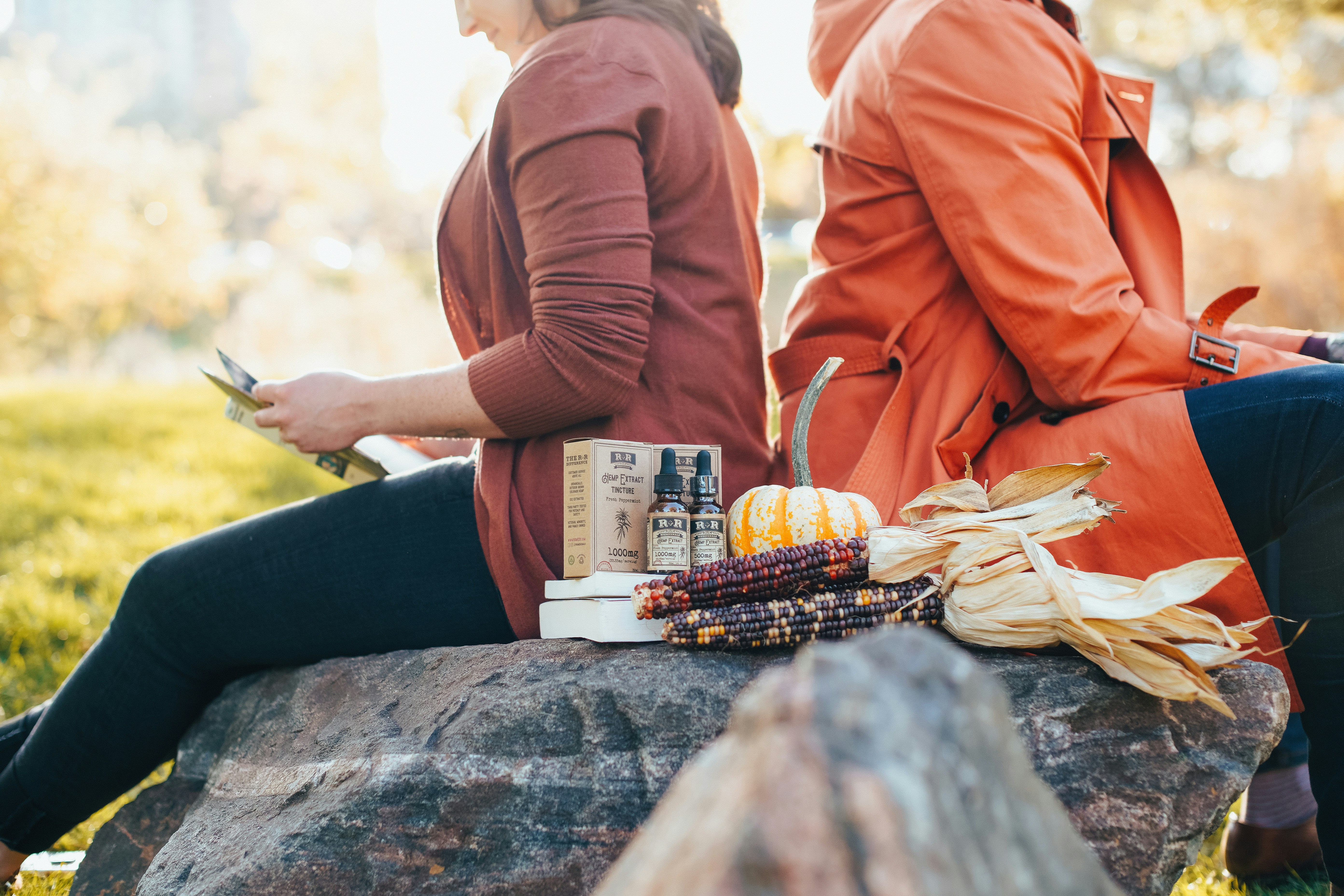 Friends reading with hemp extract tinctures during fall and autumn.