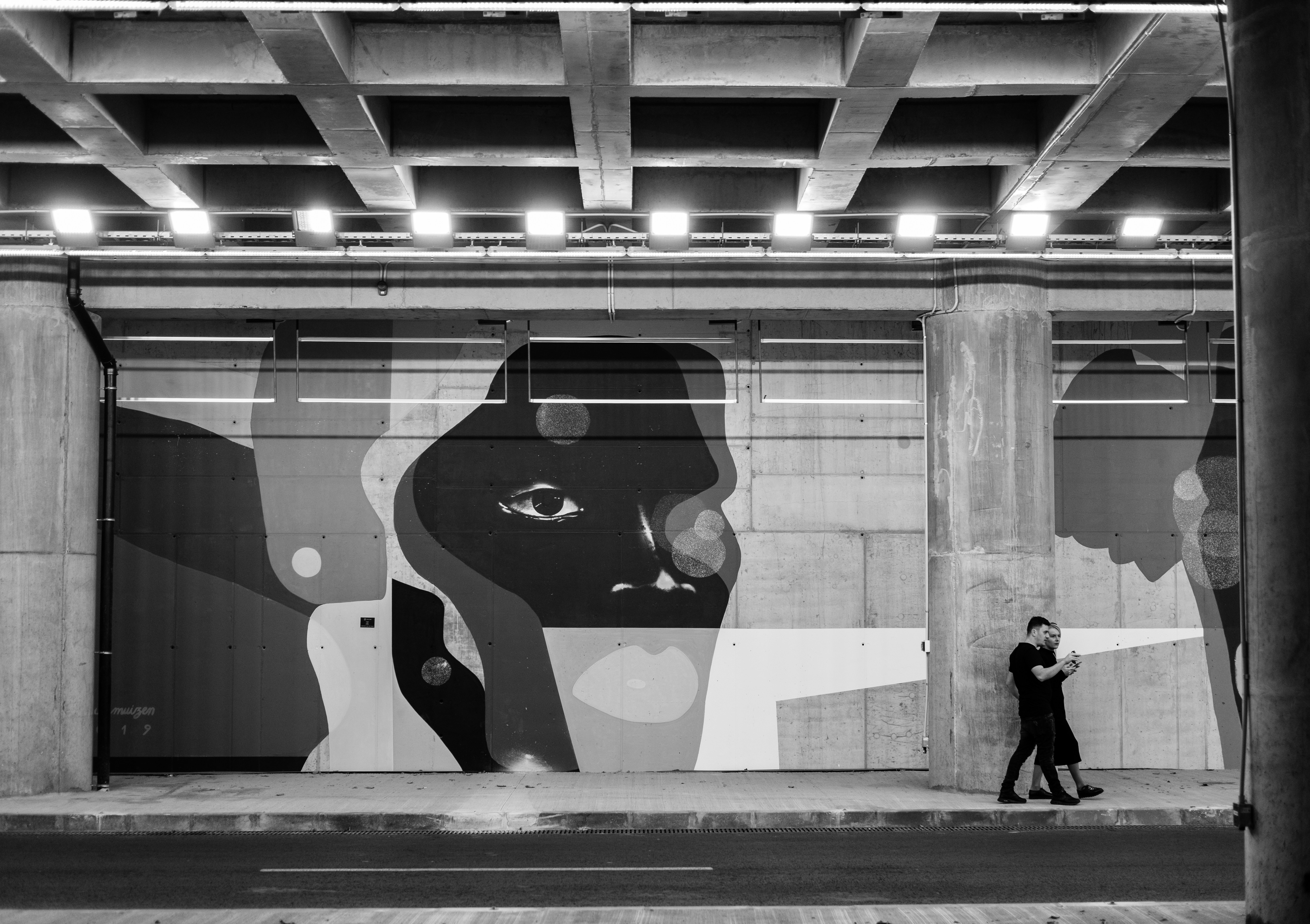 two person standing beside wall