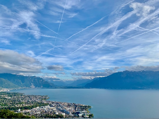 body of water near mountains at daytime in Vevey Switzerland