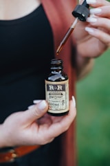 person holding dropper bottle