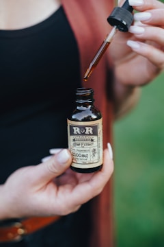 person holding dropper bottle