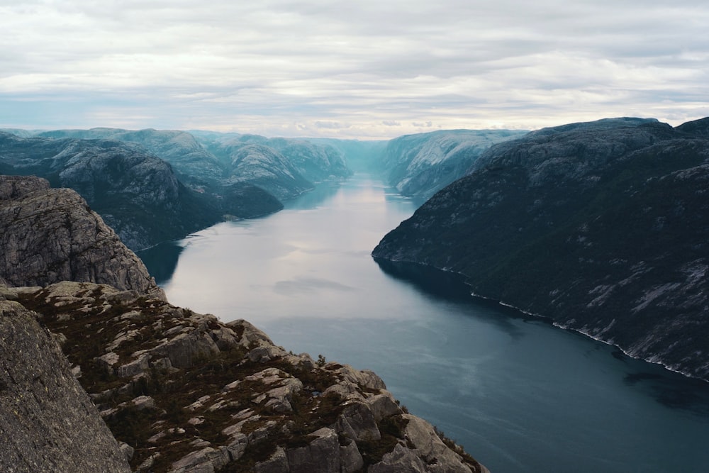 body of water between mountains at daytime