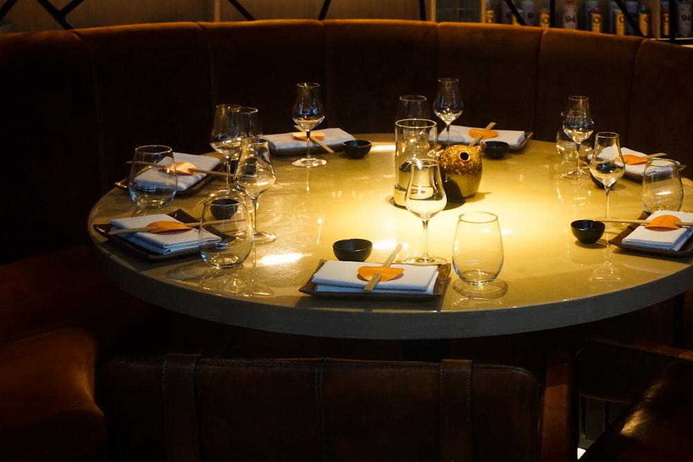 drinking glass and wine glasses on top of brown table