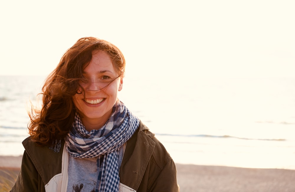 woman wears white and black scarf