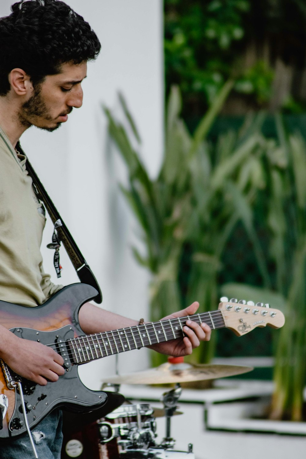 man playing stratocaster electric guitar