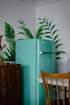 blue refrigerator beside green-leafed plant