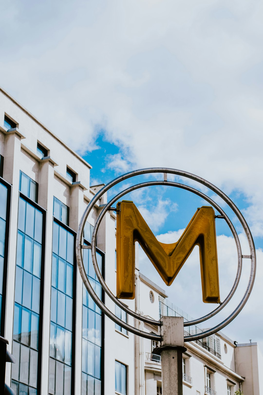 round gray metal frame with yellow M logo signage