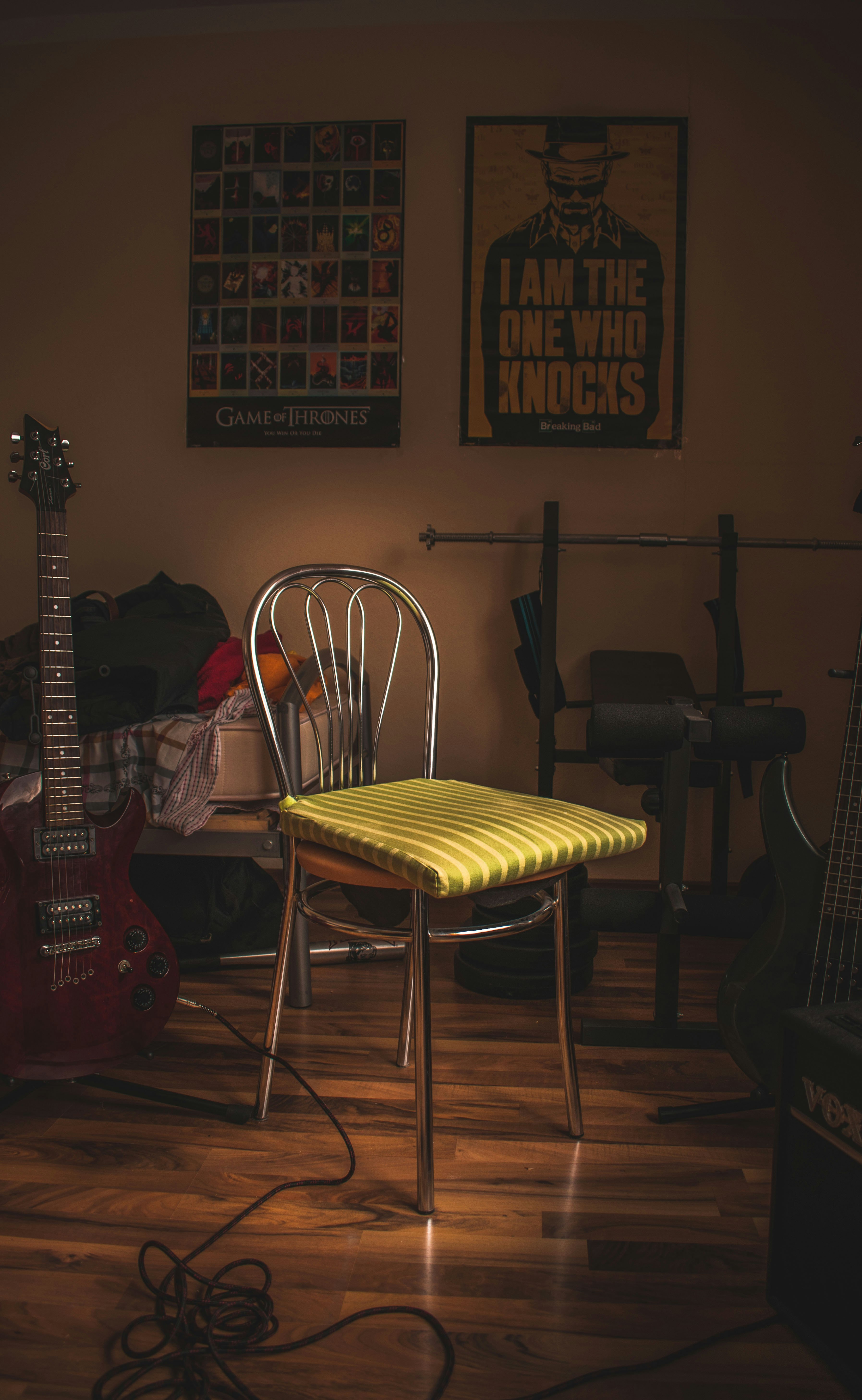 green cloth on chair near guitar