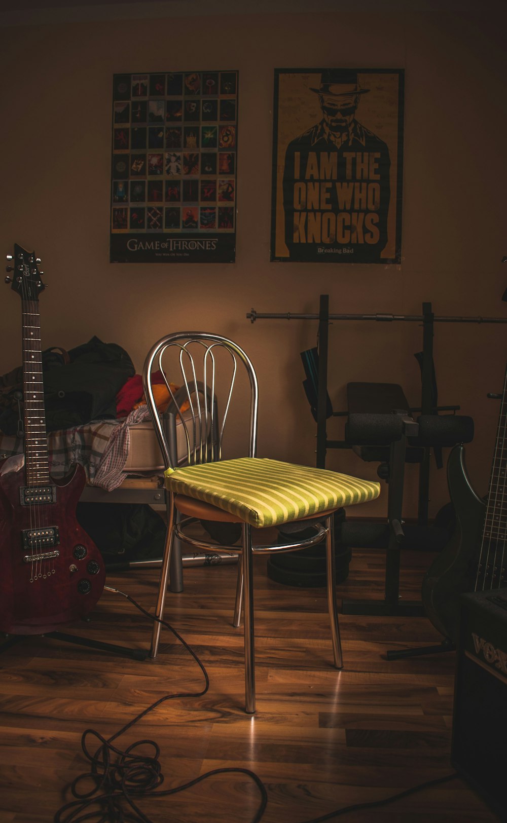 green cloth on chair near guitar