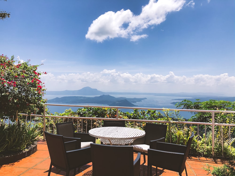 white table with chairs near balustrade