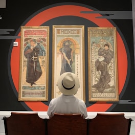 man looking at paintings