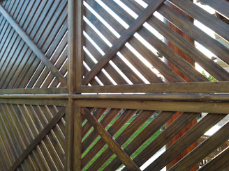 Modern horizontal slat wood fence bordering a Langley garden with lush greenery.