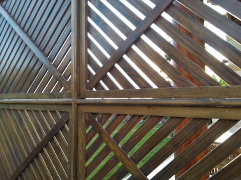 Modern horizontal slat wood fence bordering a Langley garden with lush greenery.