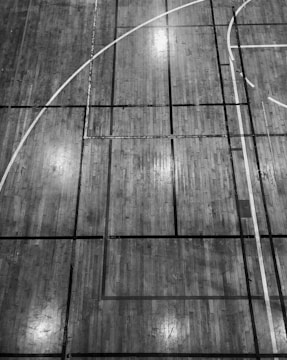 After photo of the same school gym floor gleaming with a fresh, polished finish.