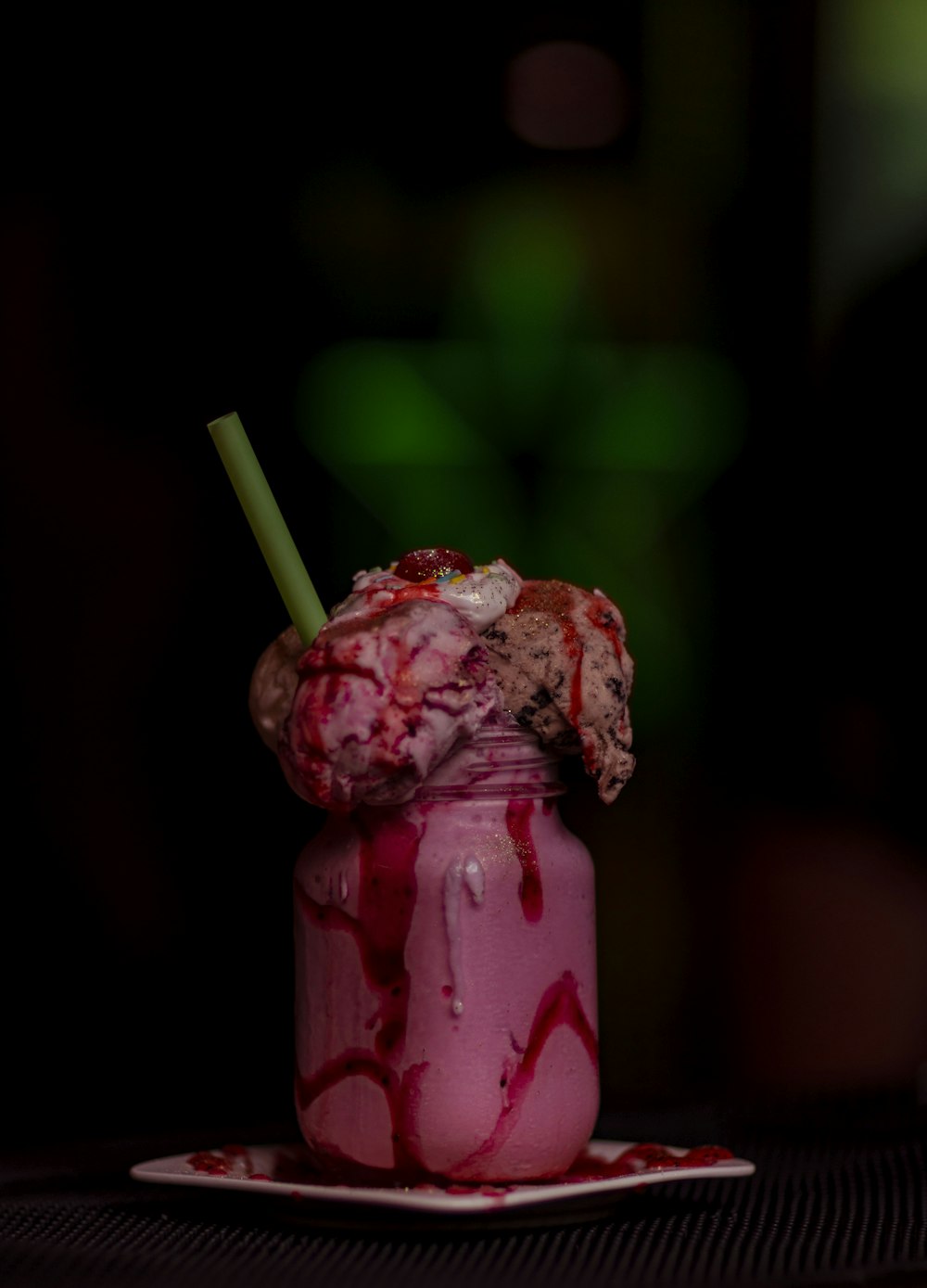 ice cream filled jar on plate with straw