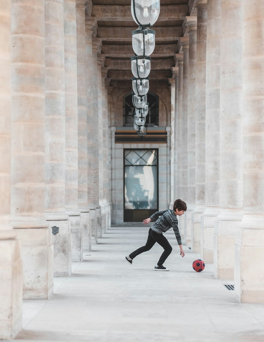 child playing ball on hallway