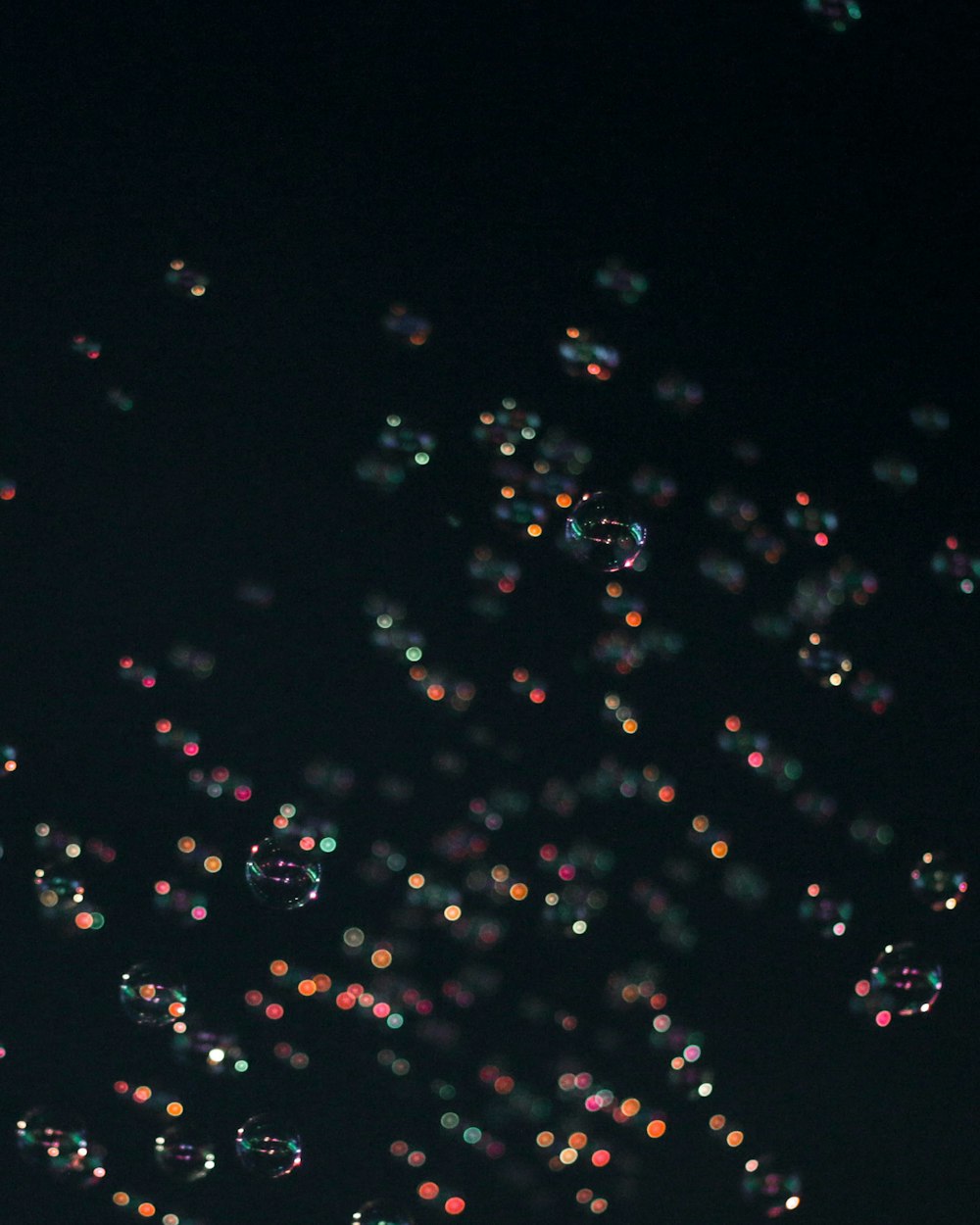 a lot of bubbles floating in the air at night