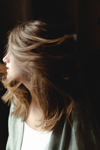 A close-up of healthy, shiny hair flowing in the wind.
