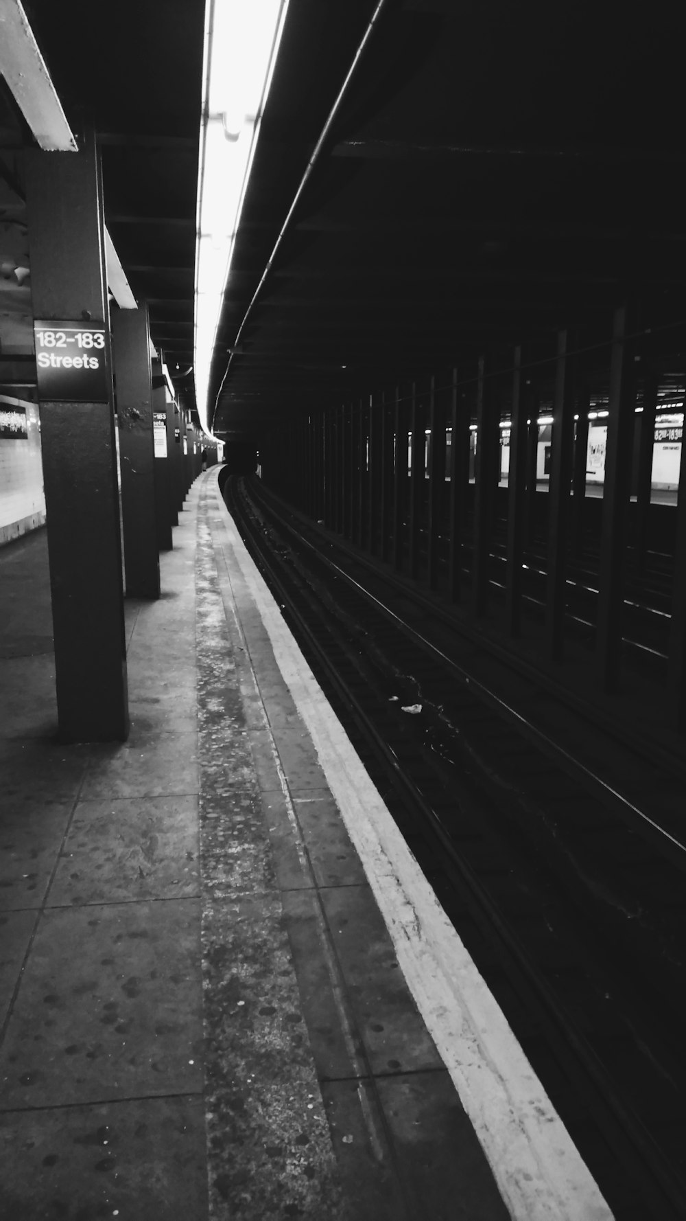 gray-scale photo of train platform