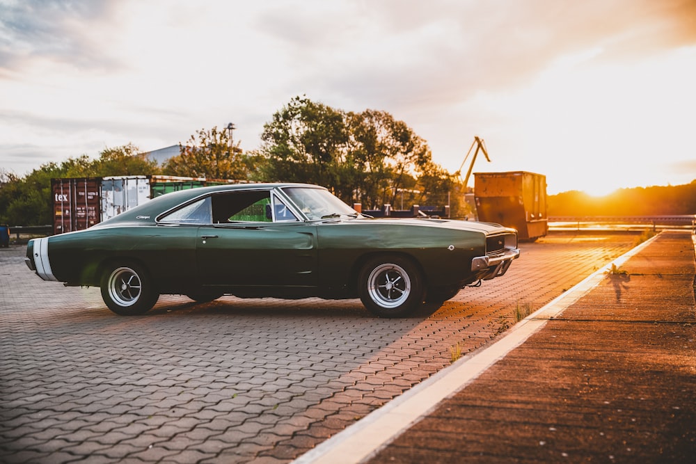 green Dodge Challenger coupe parking near road