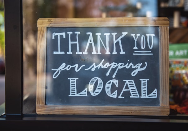 shallow focus photo of thank you for shopping signage